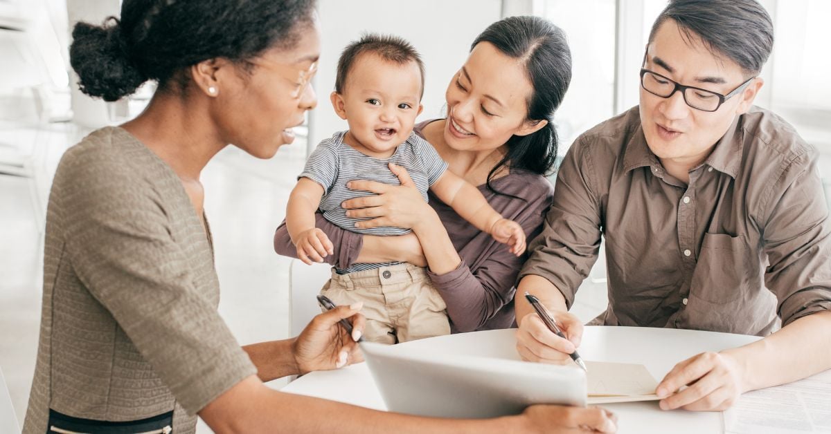 A family reviewing employee forms with their child.