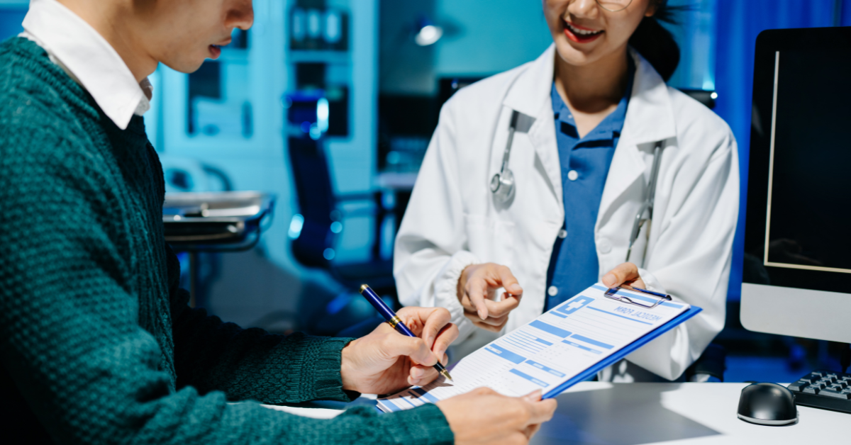 Someone signing a consent form in a medical setting.