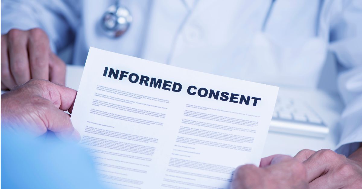 A patient holding an informed consent document.