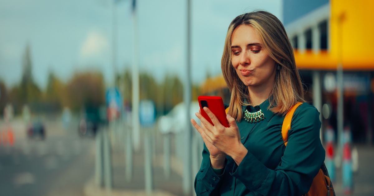 A woman looking skeptical at her phone