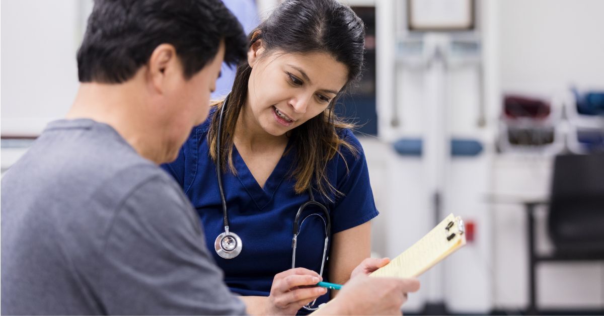 A nurse assisting a patient with hospital paperwork.